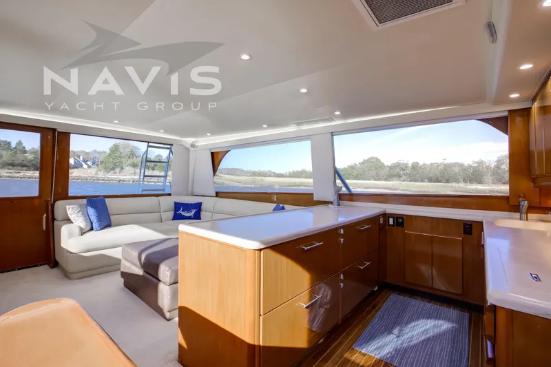 Slide: The Image of Luxurious 1998 Viking 58 Convertible yacht helm with modern navigation equipment and scenic waterway view. - 27