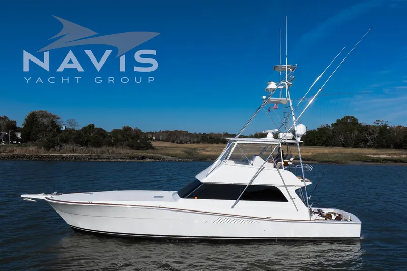 Slide: The Image of 1998 Viking 58 Convertible yacht cruising on a sunny day, Navis Yacht Group logo visible. - 3
