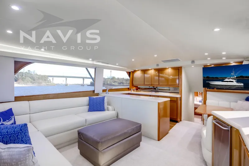 Slide: The Image of Luxurious 1998 Viking 58 Convertible yacht helm with modern navigation equipment and scenic waterway view. - 30