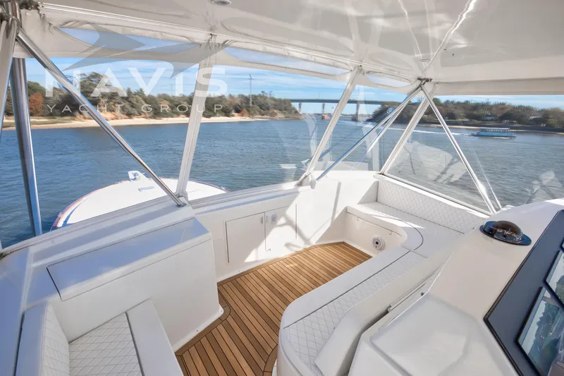 Slide: The Image of 1998 Viking 58 Convertible yacht helm with scenic river view. - 35