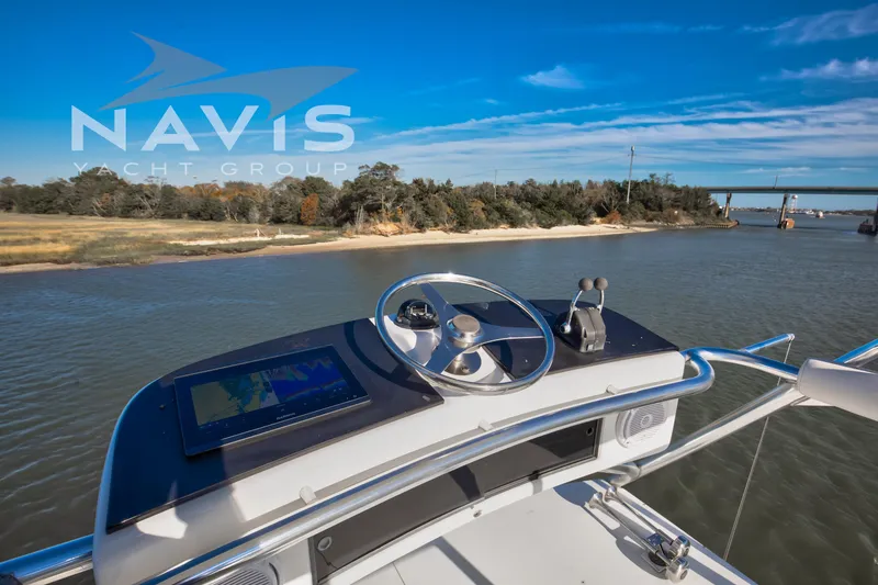 Slide: The Image of Overhead view of 1998 Viking 58 Convertible yacht on water, Navis Yacht Group branding visible. - 37