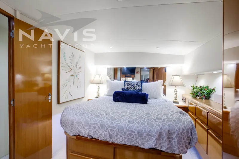 Slide: The Image of Luxurious VIP stateroom with modern amenities with under bunk storage, hanging cedar closet and other drawers and cabinets for ample storage. - 43