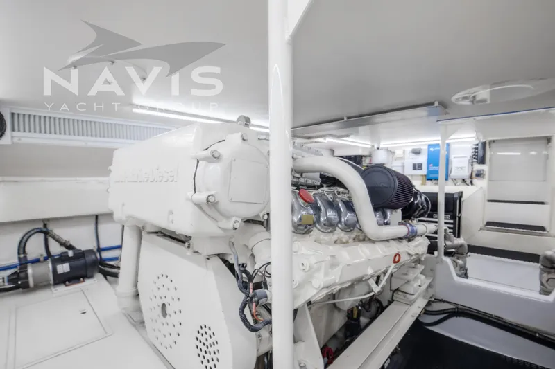 Slide: The Image of Engine room of 1998 Viking 58 Convertible yacht, featuring advanced machinery and clean design. - 51