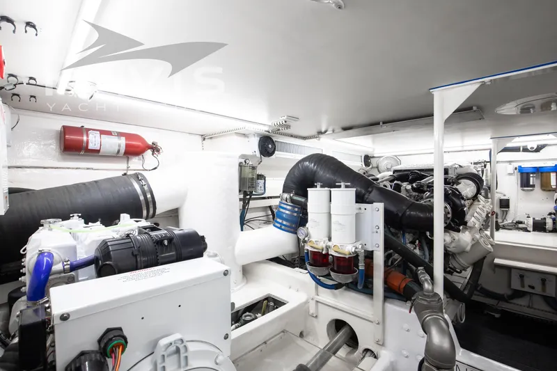 Slide: The Image of Engine room of 1998 Viking 58 Convertible yacht, featuring modern equipment and fire safety measures. - 53