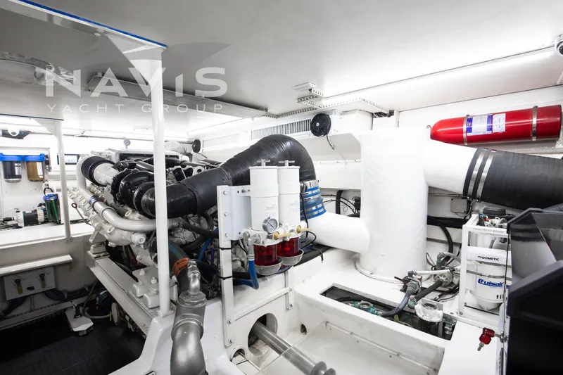 Slide: The Image of Engine room of 1998 Viking 58 Convertible yacht, featuring modern equipment and systems. - 54
