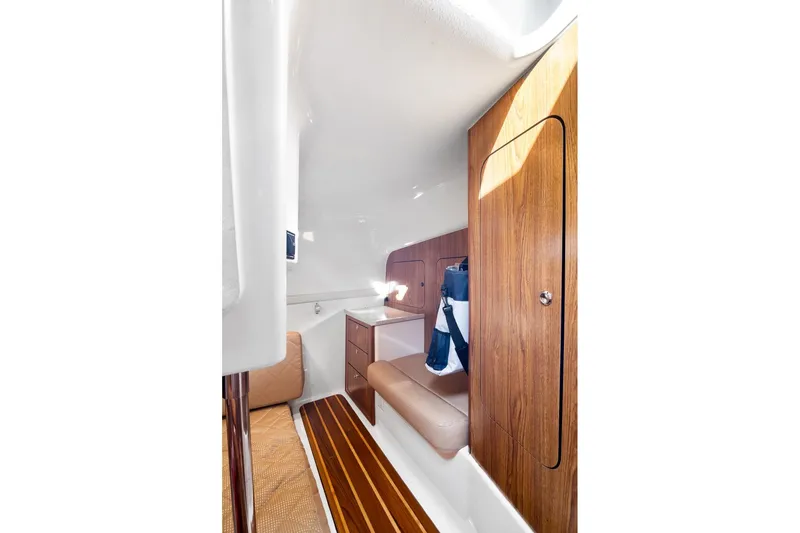 Slide: The Image of 2013 Pursuit OS 345 Offshore cabin interior with wood paneling and seating. - 10