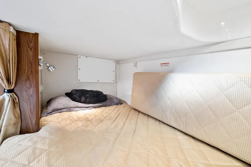 Slide: The Image of Cozy cabin interior of 2013 Pursuit OS 345 Offshore boat with bed and reading light. - 11
