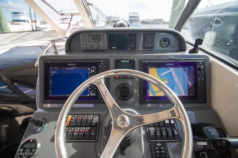 Slide: The Image of Helm of 2013 Pursuit OS 345 Offshore boat with navigation screens and controls. - 14