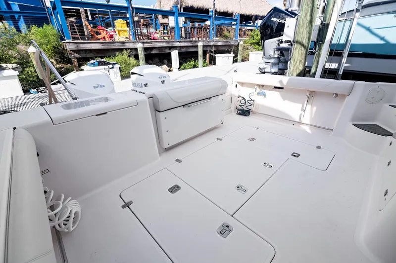 Slide: The Image of 2013 Pursuit OS 345 Offshore boat deck with storage compartments and seating. - 21