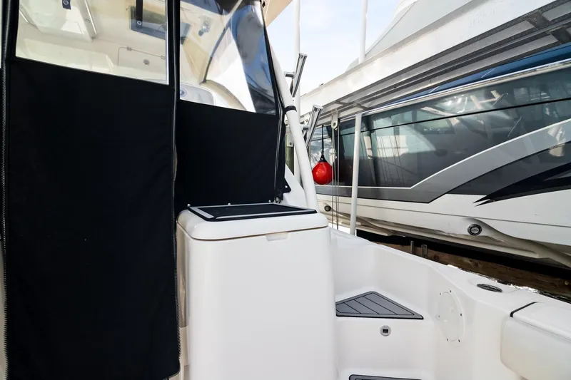 Slide: The Image of 2013 Pursuit OS 345 Offshore boat interior with black and white design elements. - 24