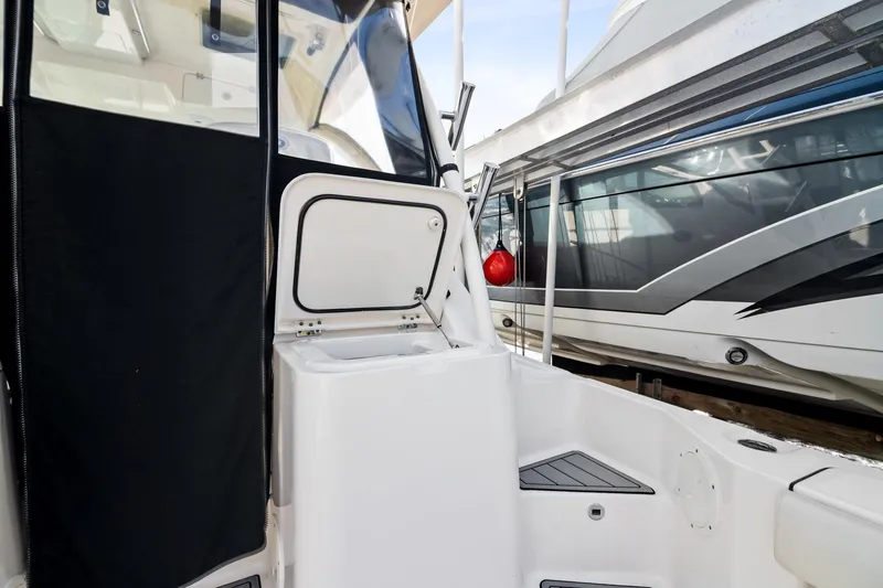 Slide: The Image of 2013 Pursuit OS 345 Offshore boat interior with open storage compartment. - 25