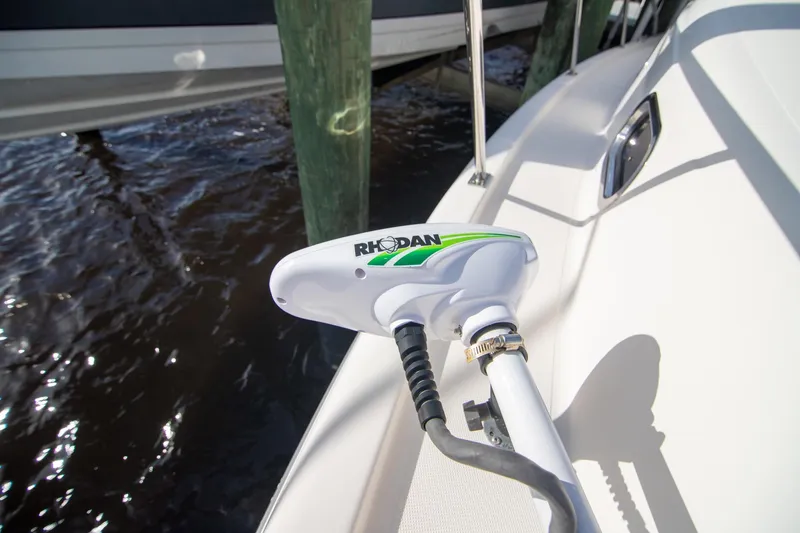 Slide: The Image of Rhodan trolling motor on 2013 Pursuit OS 345 Offshore boat docked by water. - 26