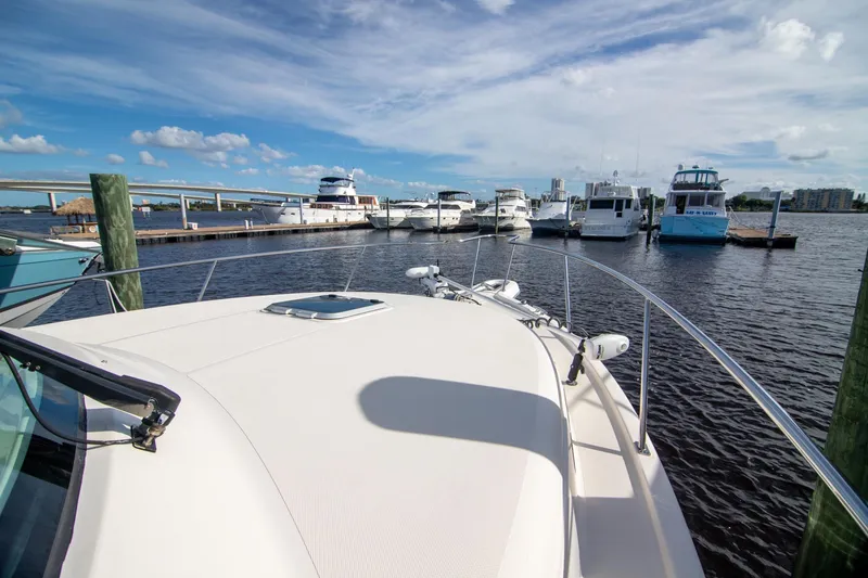 Slide: The Image of 2013 Pursuit OS 345 Offshore boat docked at marina under blue sky. - 31