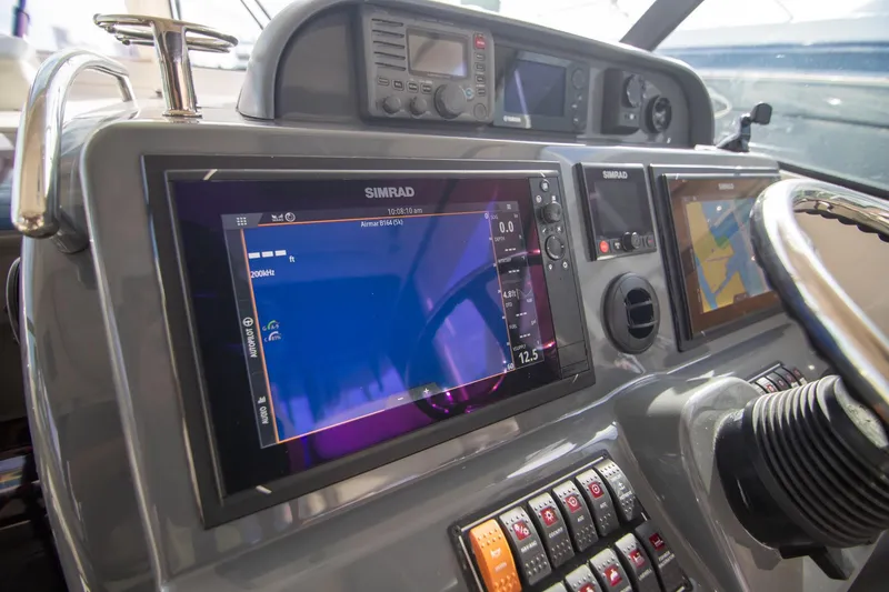 Slide: The Image of 2013 Pursuit OS 345 Offshore boat dashboard with Simrad navigation system. - 35