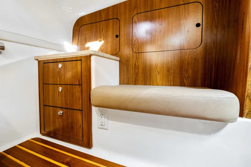 Slide: The Image of Interior of 2013 Pursuit OS 345 Offshore boat with wood cabinetry and cushioned seating. - 7