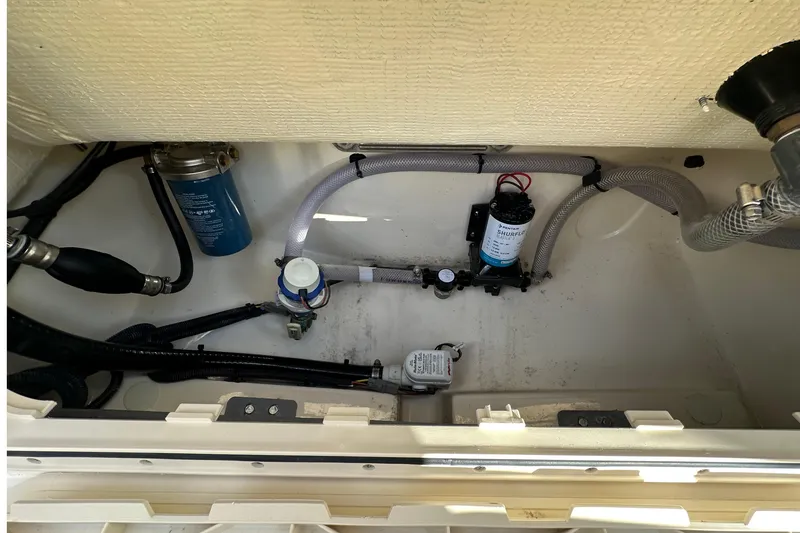 Slide: The Image of 2025 Scout 195 Sport Dorado boat interior with visible plumbing and filtration system. - 12