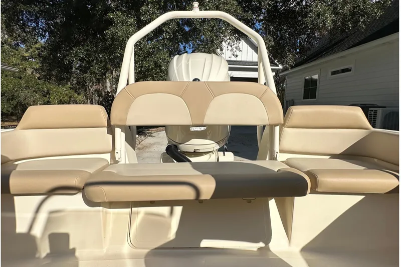 Slide: The Image of 2025 Scout 195 Sport Dorado boat interior with beige seating and outdoor setting. - 13