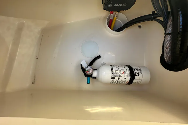 Slide: The Image of Fire extinguisher in 2025 Scout 195 Sport Dorado boat compartment. - 15