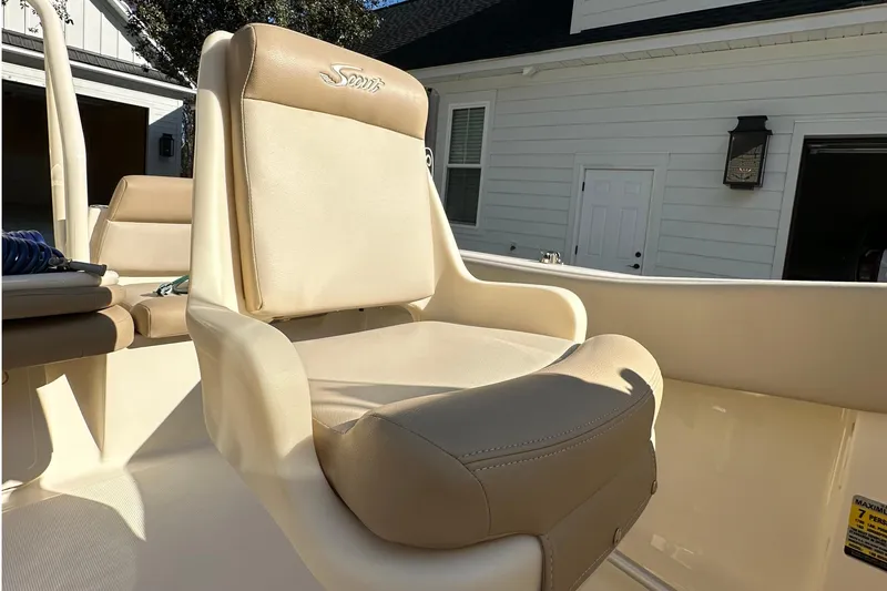 Slide: The Image of 2025 Scout 195 Sport Dorado boat seat, beige upholstery, outdoor setting. - 16