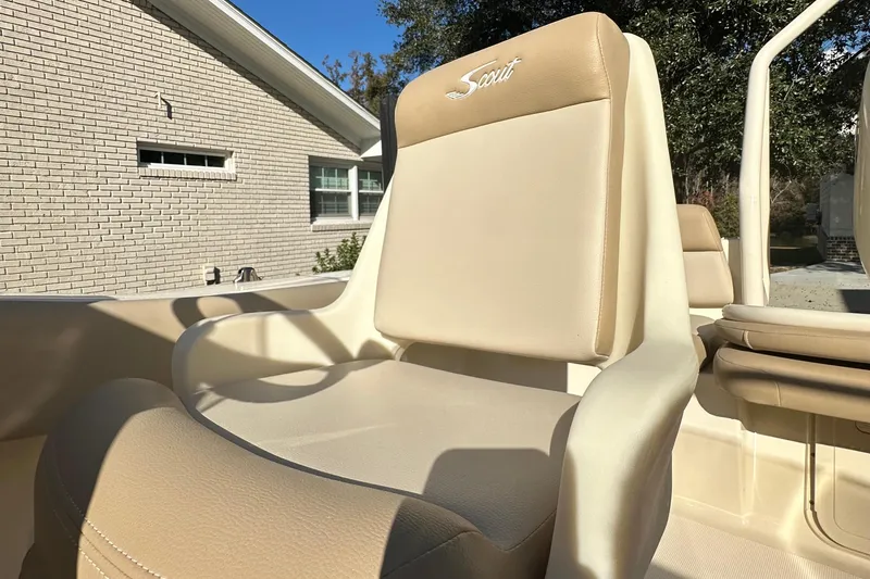 Slide: The Image of 2025 Scout 195 Sport Dorado boat seat, beige upholstery, outdoor setting. - 17