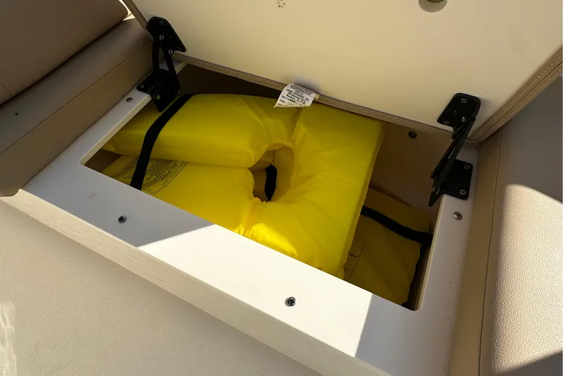 Slide: The Image of Open storage compartment in 2025 Scout 195 Sport Dorado with yellow life jacket. - 20