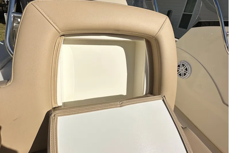 Slide: The Image of 2025 Scout 195 Sport Dorado boat seat with beige upholstery and storage compartment. - 22