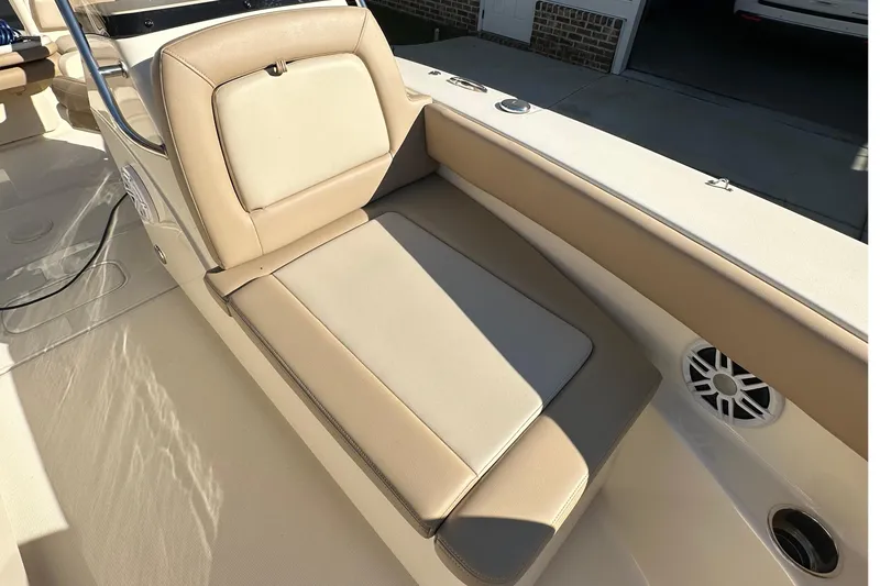 Slide: The Image of 2025 Scout 195 Sport Dorado boat interior with beige seating and speaker. - 25