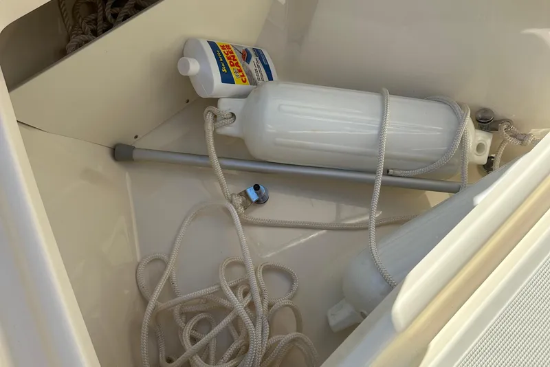 Slide: The Image of Storage compartment of 2025 Scout 195 Sport Dorado with ropes and cleaning supplies. - 28