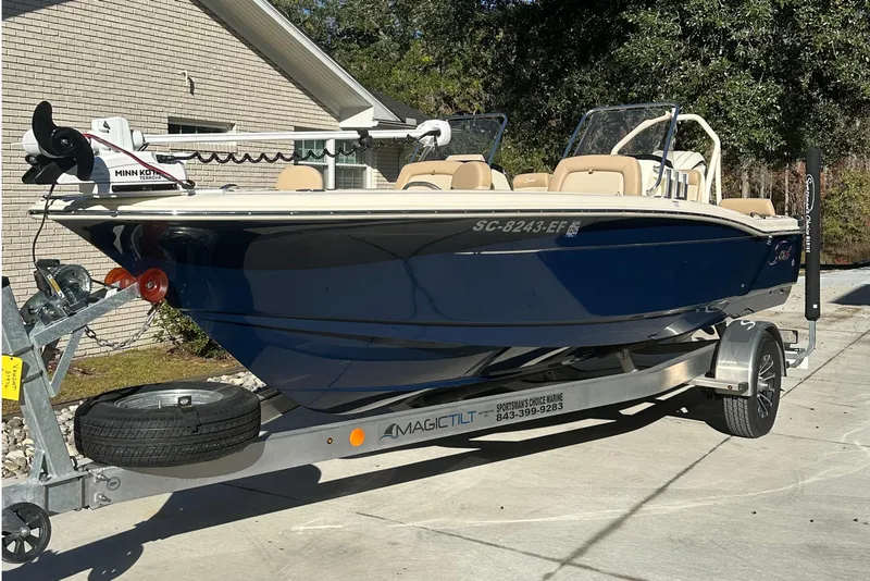 Slide: The Image of 2025 Scout 195 Sport Dorado boat on trailer, parked in driveway. - 7