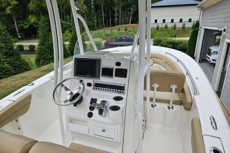 Slide: The Image of 2015 Tidewater 230 LXF boat interior with steering wheel and control panel. - 7
