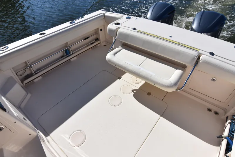 Slide: The Image of 2017 Grady-White Express 330 boat deck with seating and twin engines. - 11