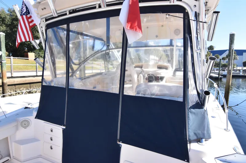 Slide: The Image of 2017 Grady-White Express 330 boat with blue canvas enclosure at dock. - 12