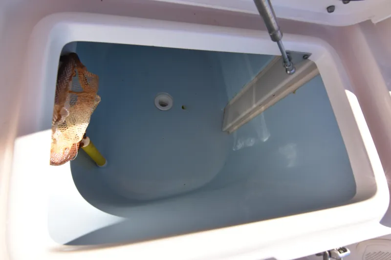 Slide: The Image of Livewell compartment on a 2017 Grady-White Express 330 boat, featuring a clean interior. - 17
