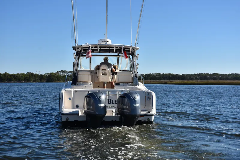 Slide: The Image of 2017 Grady-White Express 330 boat cruising on a calm lake. - 2