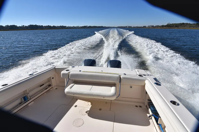 Slide: The Image of 2017 Grady-White Express 330 boat cruising on open water, leaving a wake trail. - 3