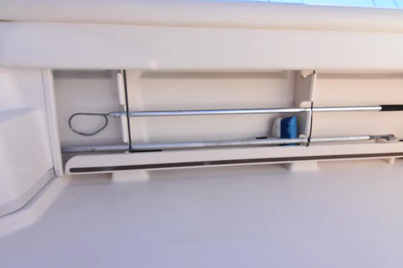 Slide: The Image of Storage compartment on 2017 Grady-White Express 330 boat, holding cleaning tools. - 31