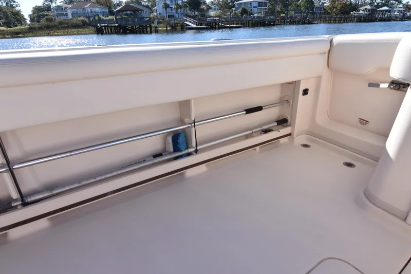 Slide: The Image of 2017 Grady-White Express 330 boat interior with rod storage, near waterfront homes. - 32