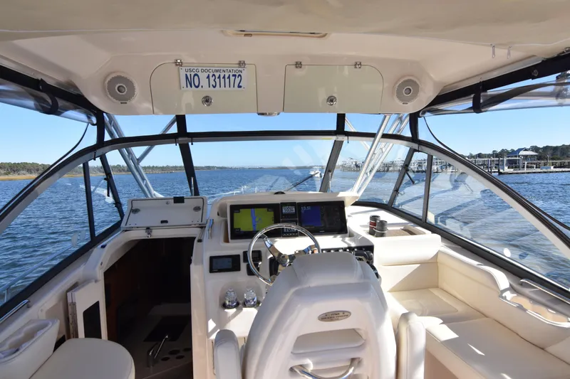 Slide: The Image of 2017 Grady-White Express 330 boat interior with navigation equipment and scenic water view. - 4