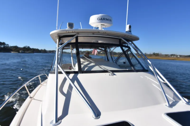Slide: The Image of 2017 Grady-White Express 330 boat cruising on a sunny day with Garmin equipment. - 40
