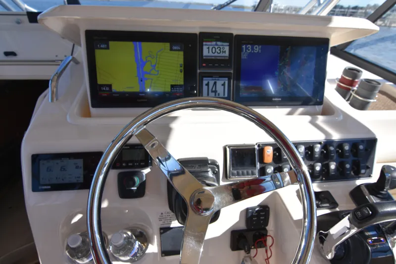 Slide: The Image of 2017 Grady-White Express 330 helm with navigation screens and controls. - 5