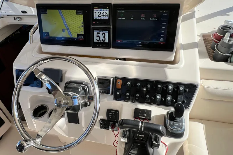 Slide: The Image of Control panel of 2017 Grady-White Express 330 boat with navigation screens and steering wheel. - 8