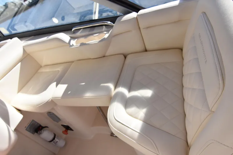 Slide: The Image of Luxurious seating on 2017 Grady-White Express 330 boat, featuring cream upholstery and diamond stitching. - 9