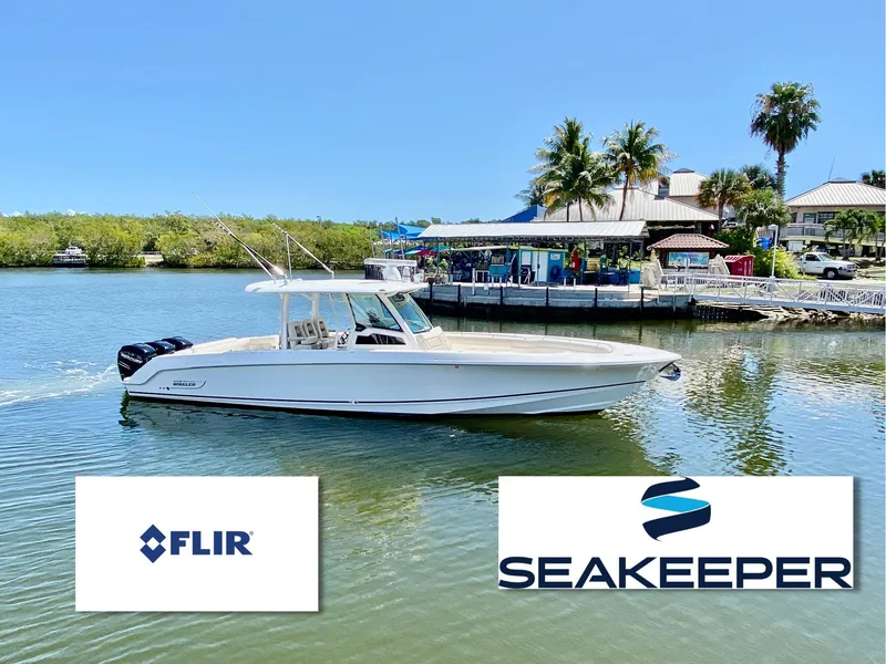 Slide: The Image of 2019 Boston Whaler 380 Outrage boat on water, featuring FLIR and Seakeeper logos. - 1