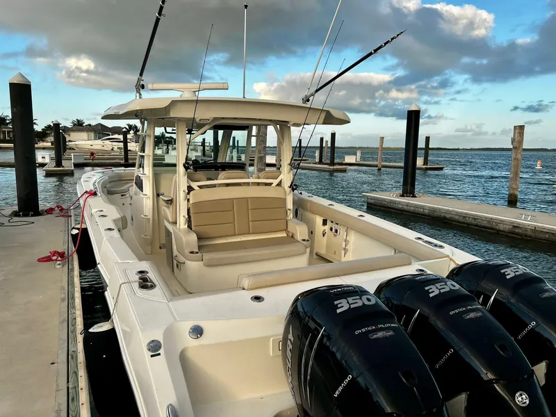Slide: The Image of 2019 Boston Whaler 380 Outrage docked, featuring triple 350 horsepower engines. - 23