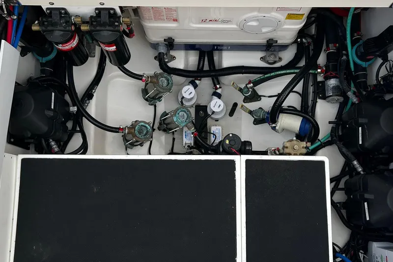 Slide: The Image of Engine compartment of a 2019 Boston Whaler 380 Outrage, showcasing intricate wiring and components. - 26