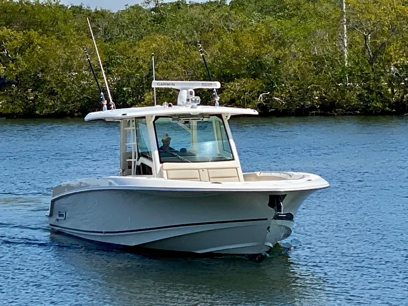 Slide: The Image of 2019 Boston Whaler 380 Outrage boat cruising on a calm river. - 5
