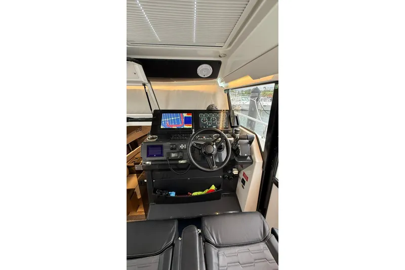 Slide: The Image of 2023 Wellcraft 355 boat cockpit with advanced navigation and control systems. - 12