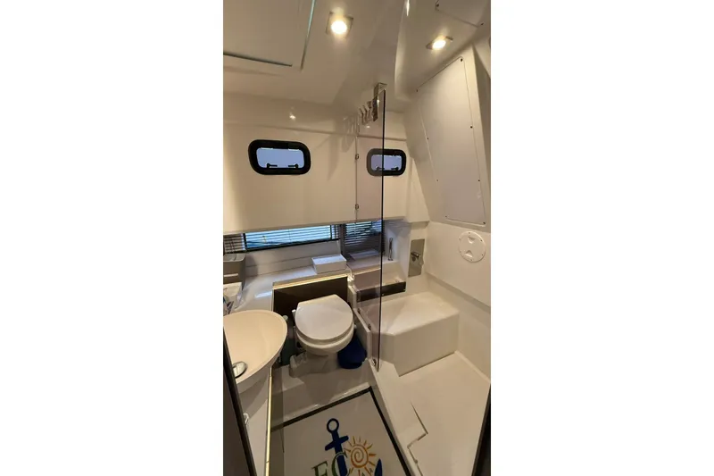 Slide: The Image of 2023 Wellcraft 355 boat bathroom interior with modern fixtures and lighting. - 16