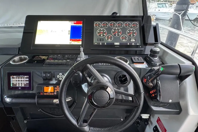Slide: The Image of 2023 Wellcraft 355 boat dashboard with advanced navigation and control systems. - 19