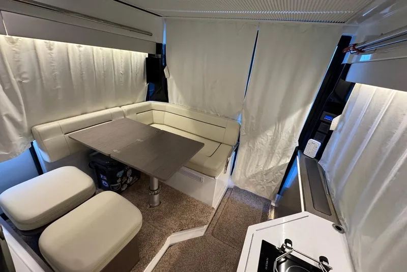 Slide: The Image of Interior of 2023 Wellcraft 355 boat with cozy seating and compact kitchen area. - 21
